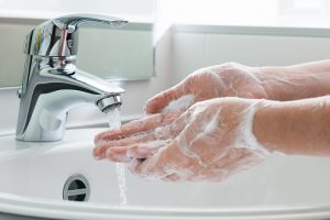A person washing hand with heavy later; handwashing is one of the best protections against germs.