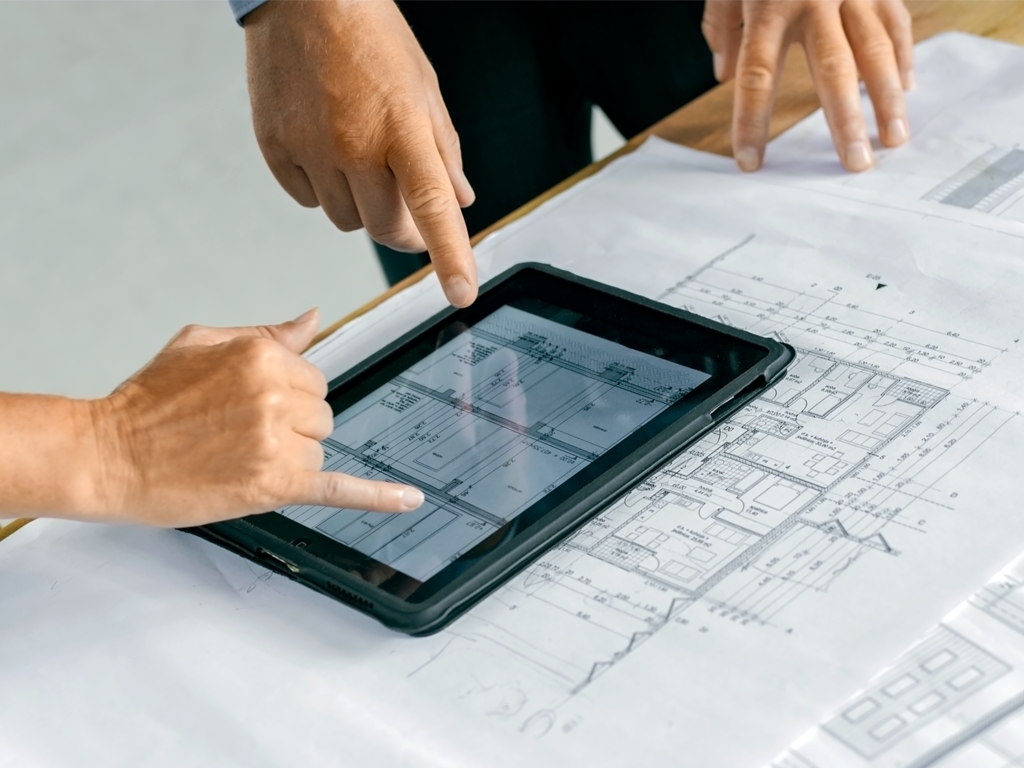 A person reviewing building plans with an expert. ActivePure will help you to understand how you can comply with the new ASHRAE 241 Indoor Air Quality Standards.