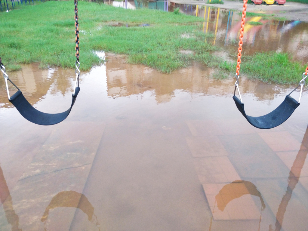 Flooded swings at a school; schools will need to adapt to local and global environmental changes such as flooding to maintain IAQ.