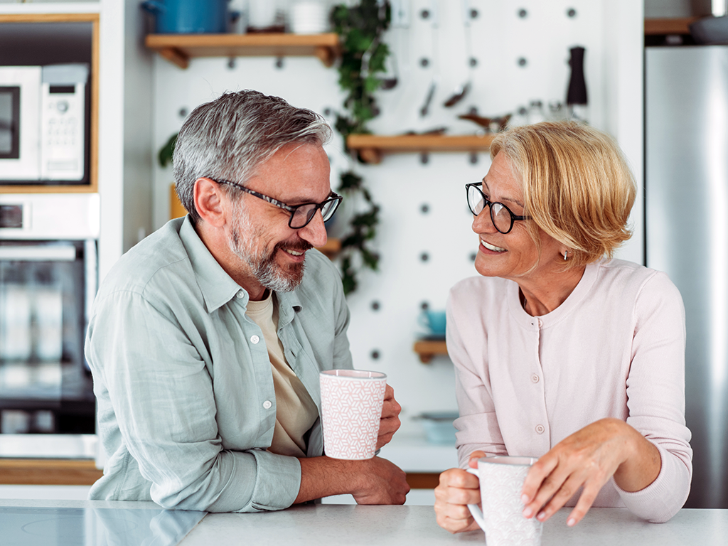 An Older man and woman drinking coffee and enjoying one another's company; RSV and HPMV affect older adults that can lead to hospitalization.