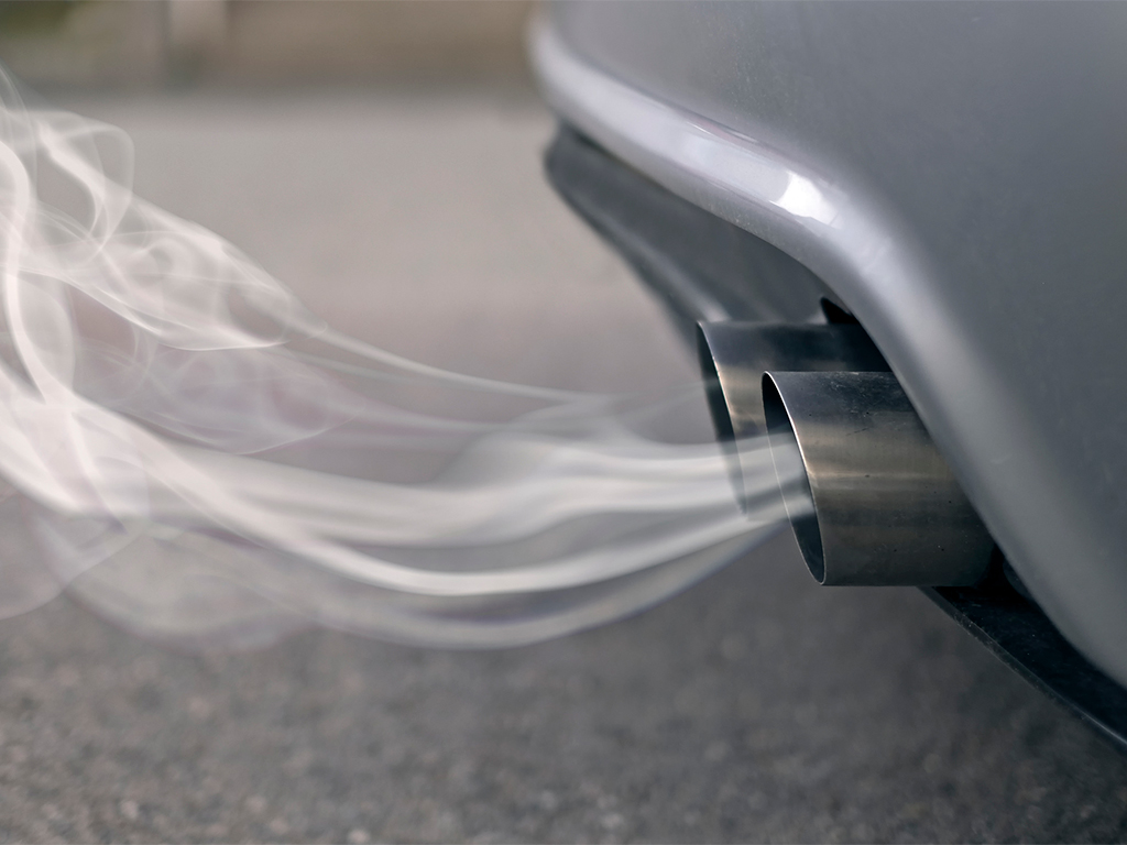 Smoke coming out of a tail pipe from a car, smoke can contain many VOCs that would need an air purifier to remove them.