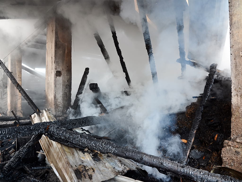 Burnt building from wildfire, Grants are available if you are unfortunately affected by a wildfire such as purchasing air purifiers for wildfire smoke.