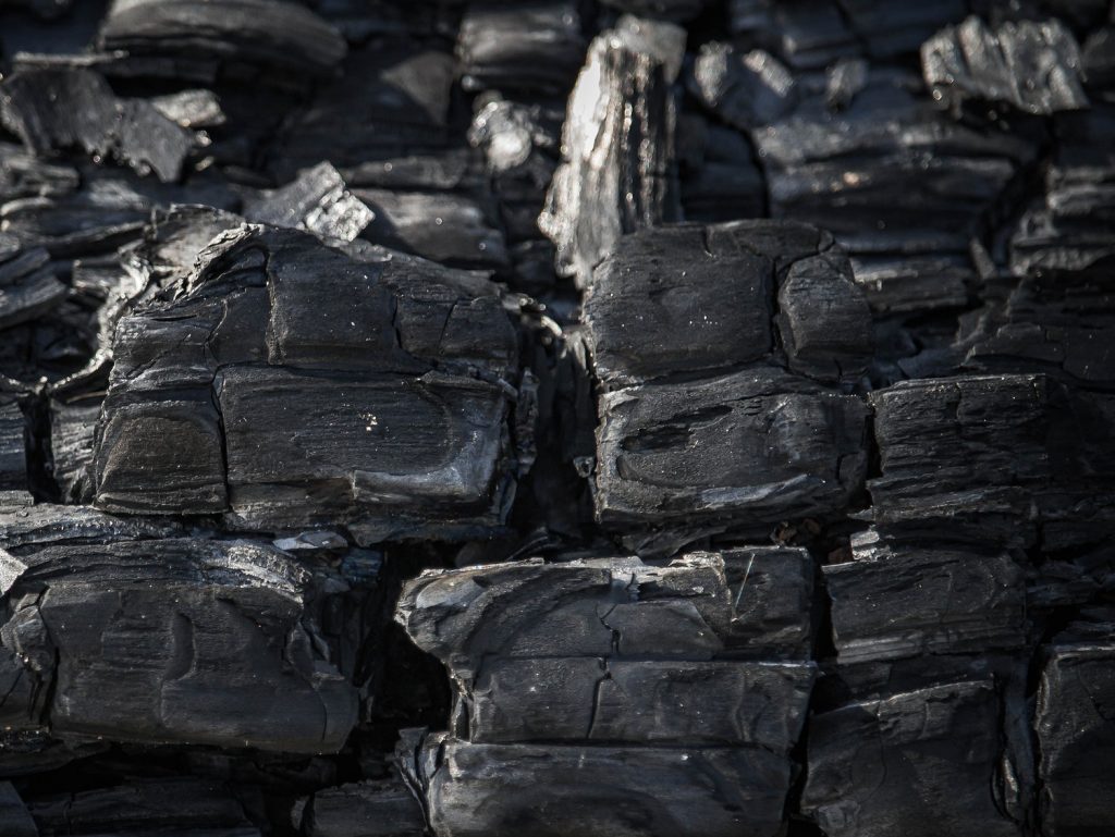 A picture of burnt wood that is now charcoal, which is used in air filtration technologies.